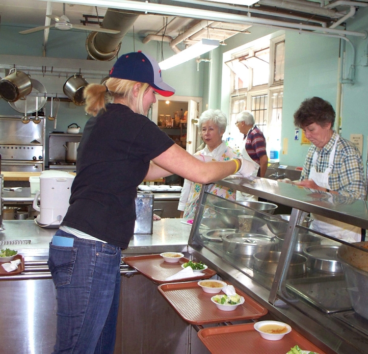 Student working in a kitchen at Loaves & Fishes