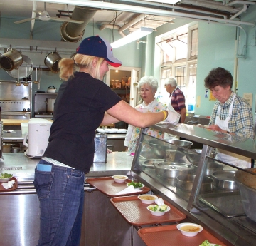 Student working in a kitchen at Loaves & Fishes