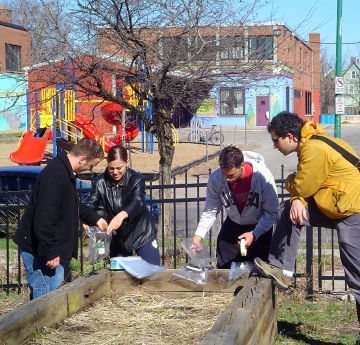 Students testing soil in a city garden