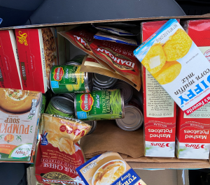 Box of canned goods and boxed foods.