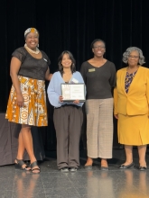 A group of people standing on stage with awards