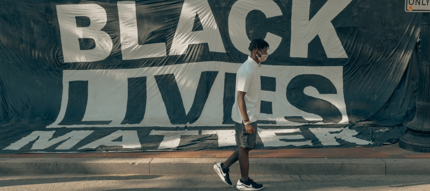 A student walks past a black lives matter banner
