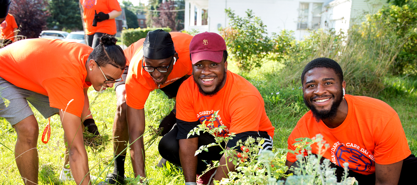 Students working in a garden on Dare to Care Day